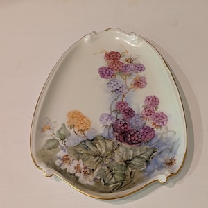 May include: A set of three ceramic mugs with a speckled, matte finish. The mugs are in shades of cream, light gray, and dark gray. Each mug has a simple, modern design and a rounded handle.