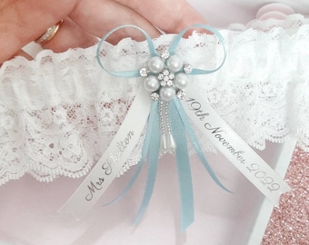 Blue personalised wedding garter with pearl centre, light blue bridal garter with name and date, personalised ribbons, something blue