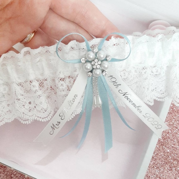 Blue personalised wedding garter with pearl centre, light blue bridal garter with name and date, personalised ribbons, something blue