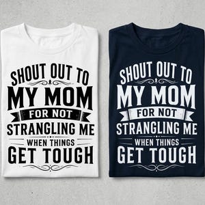 May include: Two short-sleeved t-shirts, one white with black text and one navy blue with white text. Both shirts feature the printed phrase: SHOUT OUT TO MY MOM FOR NOT STRANGLING ME WHEN THINGS GET TOUGH, arranged in a bold, multi-line graphic design.