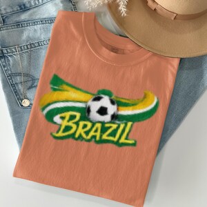 Orange t-shirt with "BRAZIL" and soccer ball graphic.