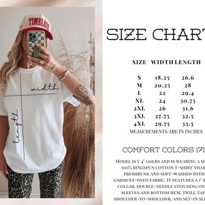 May include: A white Comfort Colors 1717 t-shirt with a size chart displaying width and length measurements in inches. The chart lists sizes S through 4XL with corresponding dimensions. The text includes fabric details and model sizing information.