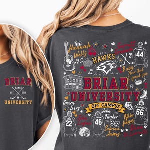 May include: A charcoal gray t-shirt featuring Briar University Hawks graphics. The front has a small logo with crossed hockey sticks. The back displays a large collage of names, hockey jerseys, a guitar, and the text Briar University Off Campus.