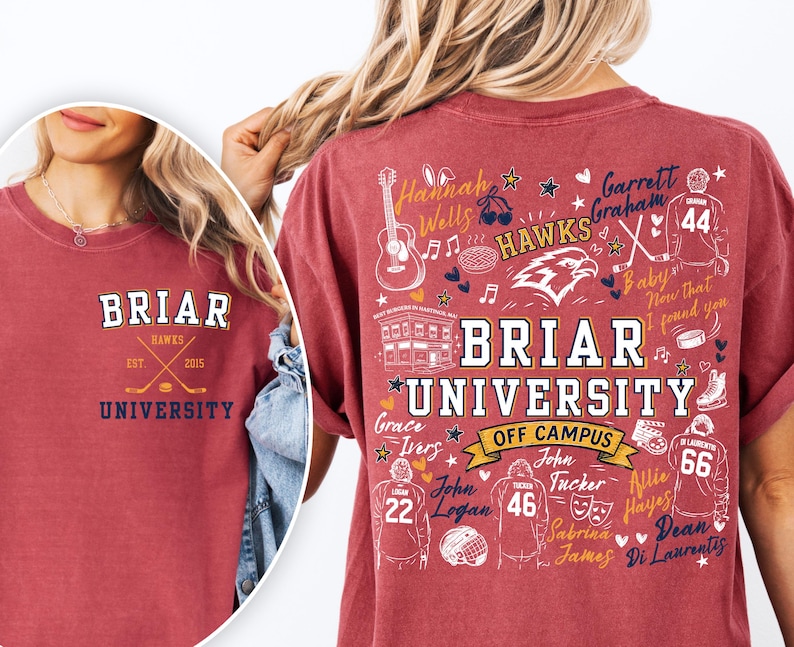 May include: A maroon t-shirt featuring a small Briar University logo on the front left chest. The back displays a large graphic with the text Briar University Off Campus, surrounded by hockey-themed illustrations, names, and jersey numbers.