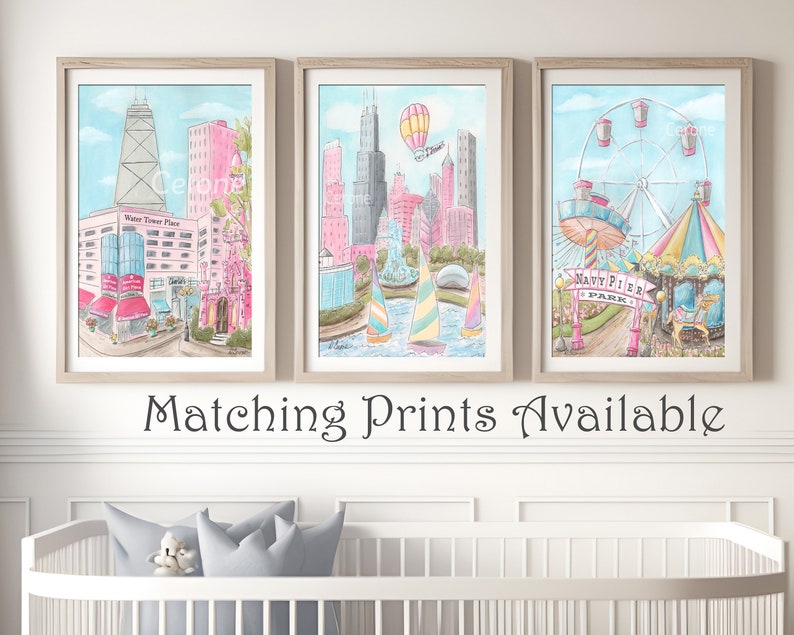 May include: Three watercolor paintings in light blue frames depicting scenes from Chicago. The first painting shows the Water Tower Place building, the second shows the Chicago skyline with a hot air balloon, and the third shows Navy Pier with a Ferris wheel and carousel.