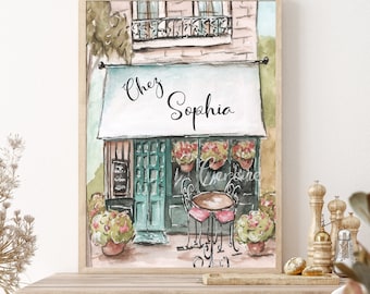 May include: A watercolour painting of a Parisian shopfront with a sign that reads "Chez Sophia". The shopfront has a green door and windows, and there are flowers in pots outside. There is a table and chairs set up for outdoor dining.