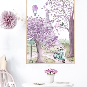 May include: A watercolor painting of the Eiffel Tower in Paris, France. The tower is surrounded by purple flowering trees and a green scooter. A hot air balloon is in the sky above the tower. The painting is framed in a gold frame.