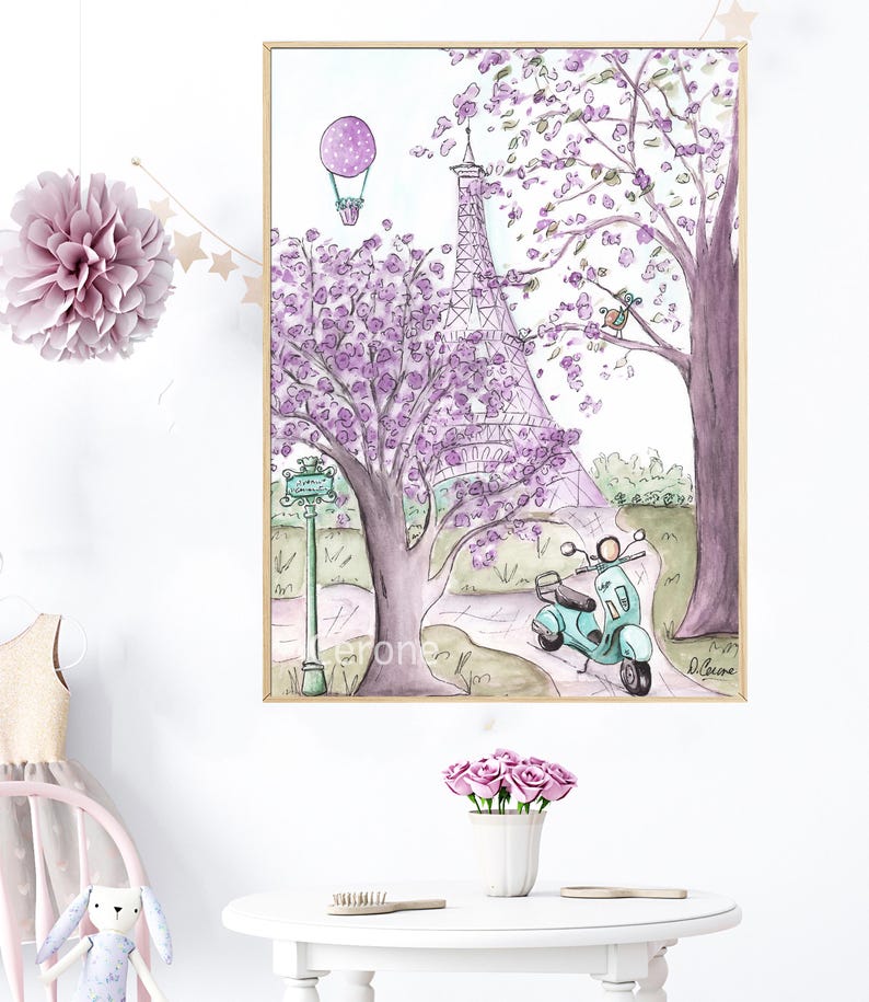 May include: A watercolor painting of the Eiffel Tower in Paris, France. The tower is surrounded by purple flowering trees and a green scooter. A hot air balloon is in the sky above the tower. The painting is framed in a gold frame.