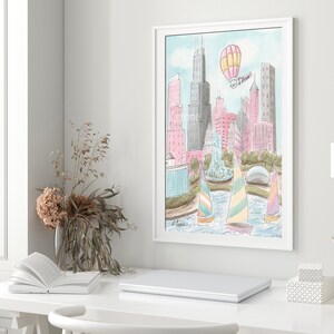 May include: A watercolor painting of the Chicago skyline with hot air balloons and sailboats in the foreground. The buildings are pink, blue, and gray. The water is blue and the sky is light blue.