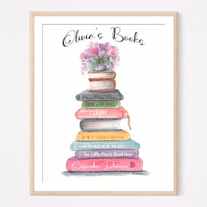 May include: A watercolor illustration of a stack of books with the title "Olivia's Books" at the top. The books are stacked in a tower with a bouquet of purple flowers on top. The titles of the books are visible: "Poppy Cakes Paris", "Pride & Prejudice", "Claris", "The Chance House in Algiers", "How to Catch a Unicorn", "Madeline", "The Little Paris Bookshop", and "Cupcake Diaries".
