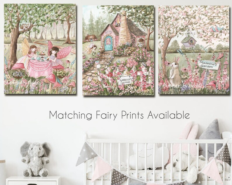 May include: A set of three whimsical fairy-themed paintings. The first painting features two fairies having tea party in a forest setting. The second painting shows a pink cottage with a blue door and a garden path. The third painting depicts a rabbit in a garden with a sign that reads "Madeline's Garden".