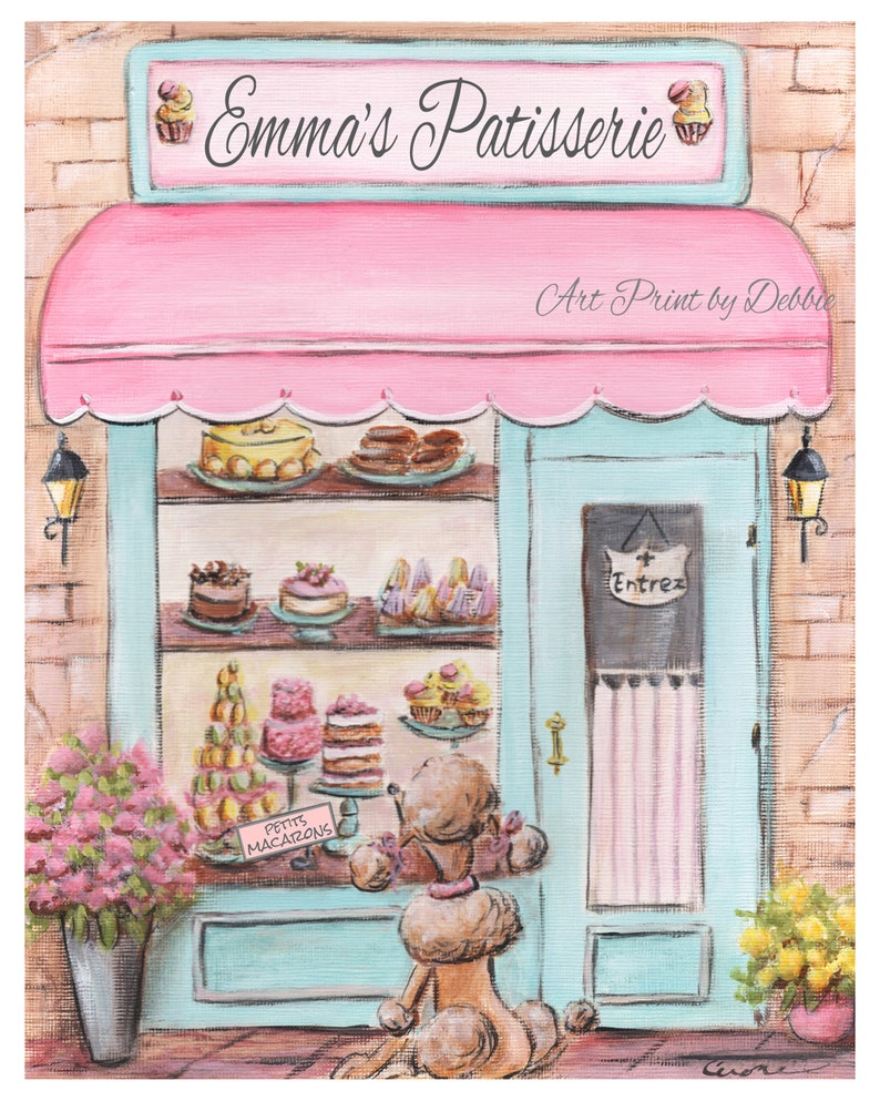 Op de afbeelding: Een kunstafdruk van een roze en blauwe patisserie, "Emma's Patisserie", met een poedel die naar de etalage met taarten en macarons kijkt. De luifel is roze en de deur lichtblauw. Het bord zegt "Entrez".