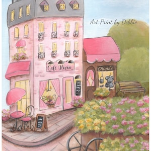 Op de afbeelding: Een kunstafdruk van een roze Parijs caf&eacute;, "Cafe Olivia", met een grijs dak en roze luifels. Een bloemenkar en zitplaatsen buiten staan ervoor. De afdruk is gesigneerd "Cerone" en zegt "Art Print by Debbie".