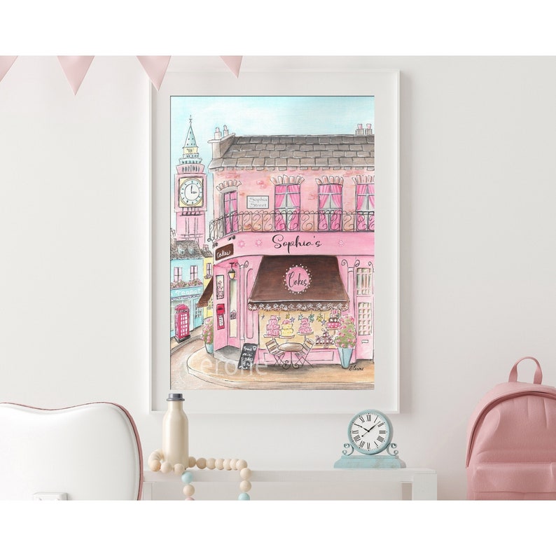 May include: A watercolor painting of a pink building with a brown awning that says "Sophia's Cakes". The building is on a street corner with a red phone booth and a clock tower in the background.