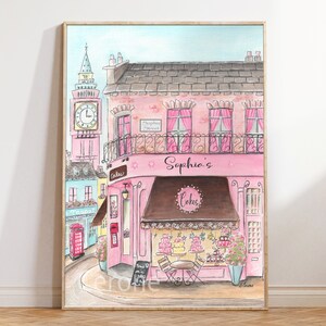 May include: A watercolor painting of a pink building with a brown awning that says "Sophia's Cakes". The building is on a street with a red telephone booth and a clock tower in the background.
