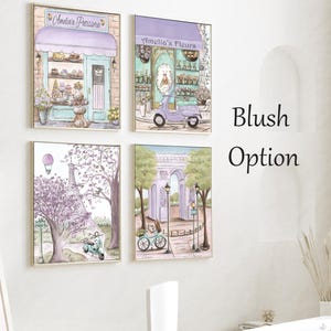 May include: Four framed illustrations in a blush color palette. The top left image shows a pastel blue storefront with the text "Amelia's Patisserie". The top right image shows a pastel blue storefront with the text "Amelia's Fleurs". The bottom left image shows a purple Eiffel Tower with a scooter in front of it. The bottom right image shows a purple archway with a scooter in front of it.