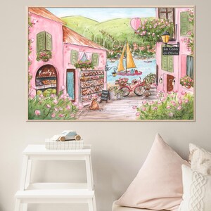 Pode incluir: Uma pintura em aquarela de um pr&eacute;dio rosa com uma placa que diz "Emily's". O pr&eacute;dio est&aacute; localizado em uma rua com uma bicicleta e um barco ao fundo. A pintura est&aacute; emoldurada em uma moldura marrom clara.
