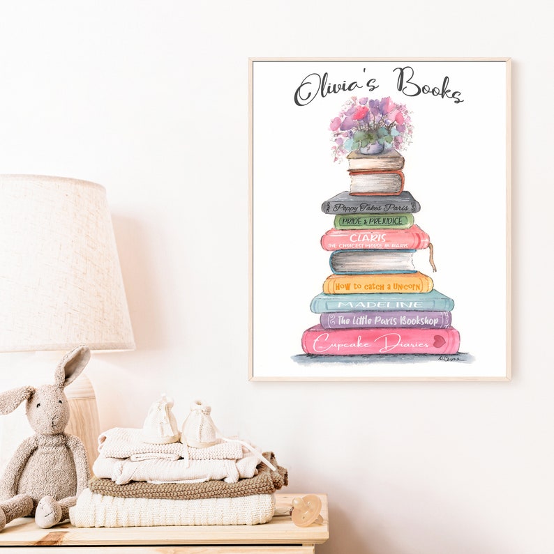 May include: A watercolor illustration of a stack of books with the title "Olivia's Books" at the top. The books are stacked in a tower with a flower pot on top. The books have titles like "Poppy Jakes Paris", "Pride & Prejudice", "Claris", "The Chicest House in Paris", "How to Catch a Unicorn", "Madeline", "The Little Paris Bookshop", and "Cupcake Diaries".