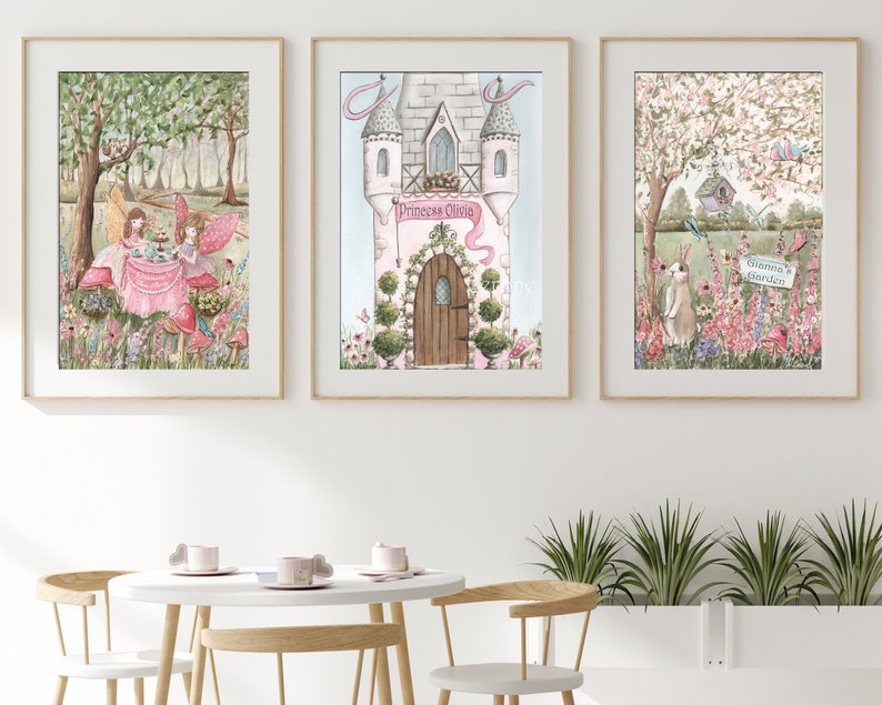 K&ouml;nnte beinhalten: Drei gerahmte Aquarelldrucke mit skurrilen Szenen. Einer zeigt Feen bei einer Teeparty, ein anderer ein Schloss mit dem Text "Princess Olivia" und der dritte einen Garten mit einem Kaninchen und dem Text "Glenna's Garden". Die Drucke haben goldene Rahmen.