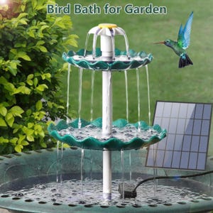 Pode incluir: Fonte para banho de p&aacute;ssaros verde de dois n&iacute;veis com &aacute;gua em cascata. A fonte tem um centro branco e &eacute; encimada por um elemento em forma de flor amarela e branca. Um painel solar &eacute; vis&iacute;vel, e o texto "Bird Bath for Garden" est&aacute; no topo.