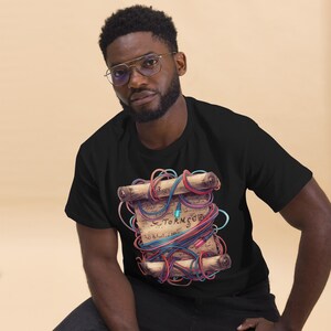 May include: Black t-shirt with a detailed illustration of a scroll tied with colourful wires. The scroll has text and a gem. The design is intricate and eye-catching, ideal for those who appreciate unique apparel.