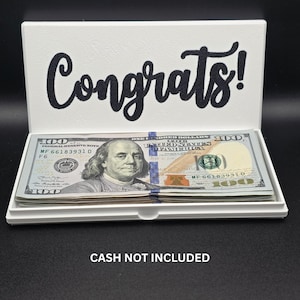 May include: A white ceramic mug with a black handle and the text "But First, Coffee" in a black, bold font. The mug is on a white surface. The mug appears to be 12 ounces.