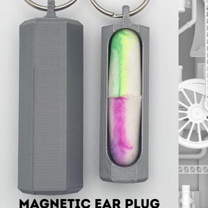 May include: Gray 3D-printed ear plug vault with a keychain ring. One vault is closed, the other holds a colorful ear plug. The text "MAGNETIC EAR PLUG VAULT" is printed below the vaults.