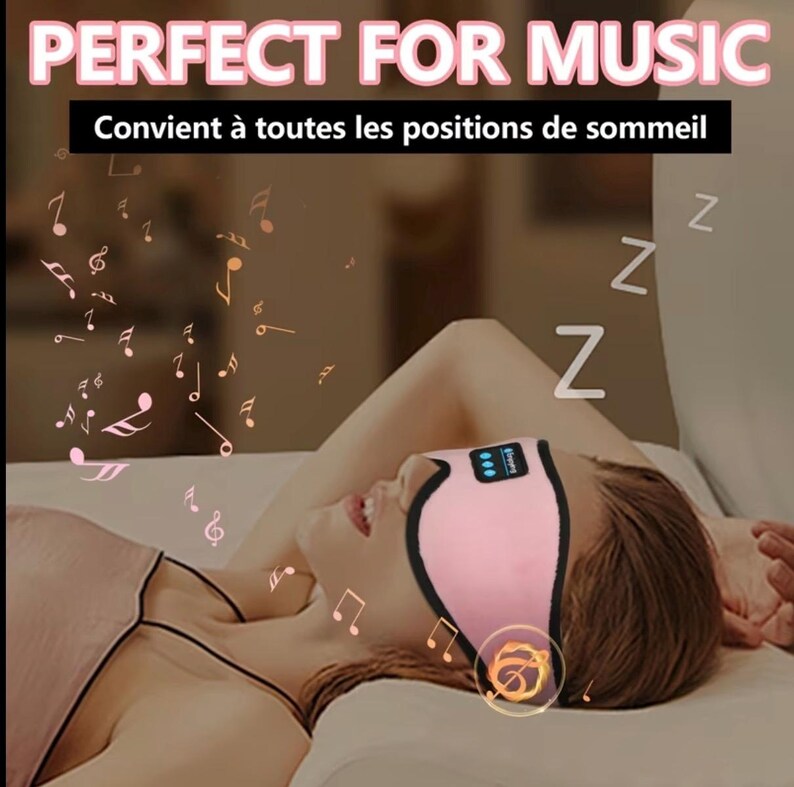 May include: Pink sleep mask with a black trim and a small digital display. The mask is worn by a person lying down. The text "PERFECT FOR MUSIC" is at the top of the image, with musical notes floating around the mask.