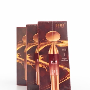 May include: Three boxes of a beauty product, each featuring a gold-colored facial massager. The boxes are a deep red with gold accents and the brand name "HIH" in white. The product is designed for skin care.