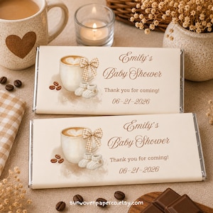 May include: Two rectangular chocolate bar wrappers featuring a beige color scheme with a coffee cup illustration, a checkered bow, and baby booties. The text reads Emily's Baby Shower, Thank you for coming!, and the date 06-21-2026 in brown script font.