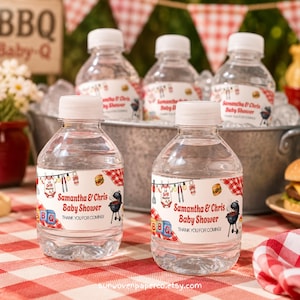 May include: Clear plastic water bottles with white caps, labeled for a baby shower. The labels feature a red and white checkered pattern, BBQ graphics, and the text "Samantha & Chris Baby Shower". The bottles are displayed on a red and white checkered tablecloth.