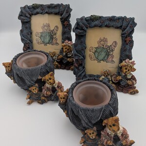 May include: Two rectangular picture frames and two round candle holders featuring sculpted teddy bears. The frames have dark blue textured borders and contain illustrations of a bear with yarn. The candle holders are shaped like yarn balls.