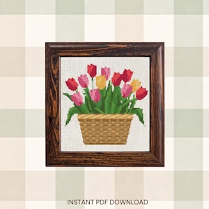 May include: Cross-stitch artwork of a basket of tulips in a dark wooden frame. The tulips are red, pink, and yellow with green leaves. The text "INSTANT PDF DOWNLOAD" is below the frame.