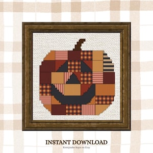 May include: A cross-stitch pattern of a pumpkin made from various patchwork squares in shades of orange, brown, and black, framed in a dark wood border. The text INSTANT DOWNLOAD and Keeepsake Kays on Etsy appear below the framed image.
