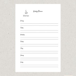 May include: A white weekly planner with a minimalist design. The planner includes sections for each day of the week, with lines for notes. The top of the planner features the words "Weekly Planner" and a coffee cup icon. The text "But first coffee" is also included.