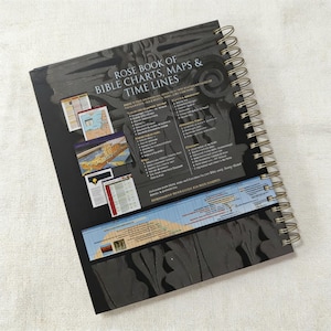May include: A spiral-bound book titled "Rose Book of Bible Charts, Maps & Time Lines" with a black cover. The cover features architectural details and several smaller images. A timeline is visible at the bottom.