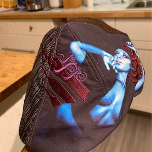 May include: A white ceramic mug with a black handle and the text "But First, Coffee" in a black, bold font. The mug is on a white surface.