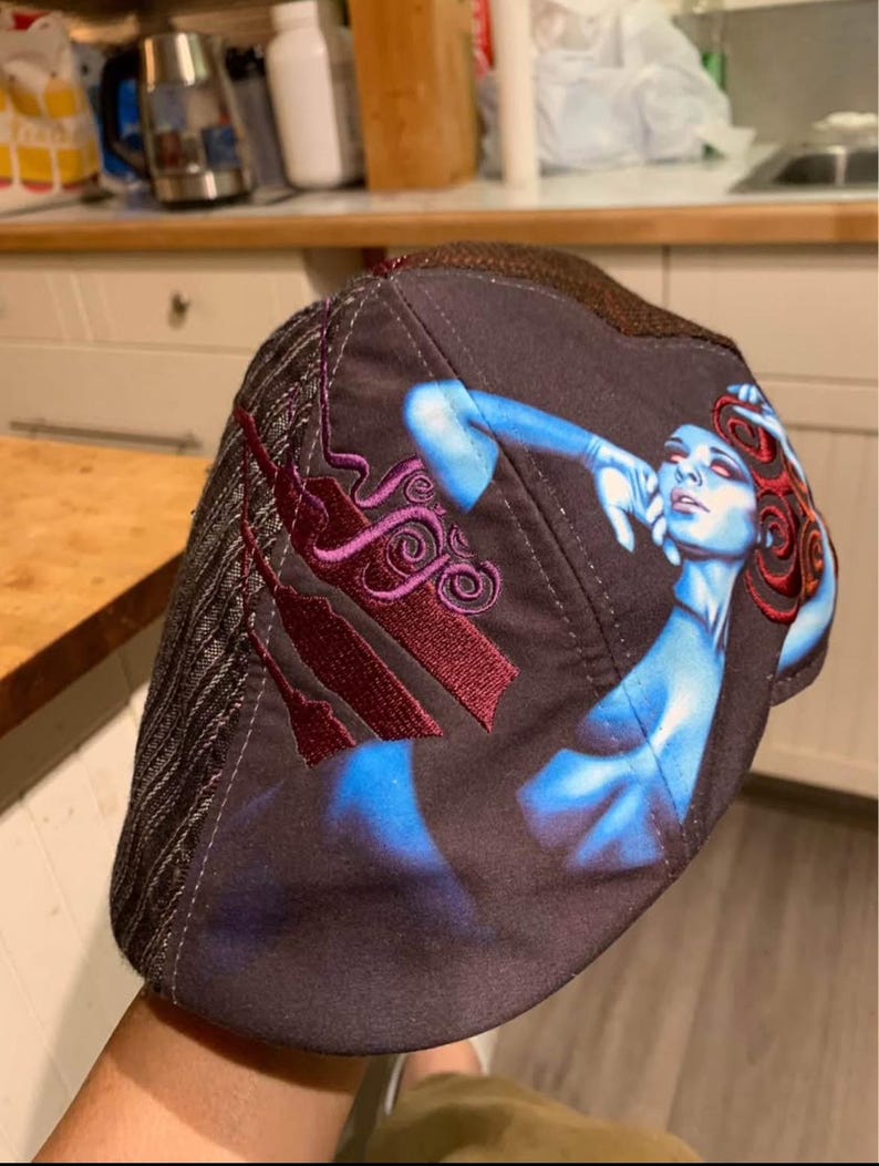 May include: A white ceramic mug with a black handle and the text "But First, Coffee" in a black, bold font. The mug is on a white surface.