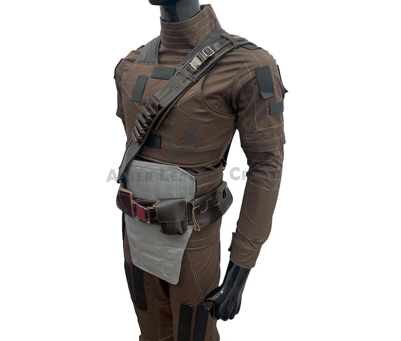 May include: A brown tactical costume with a shoulder strap, belt, and pouches. The outfit features a high collar, multiple pockets, and a grey protective panel. The mannequin is on a white background.