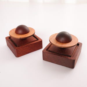 May include: A rustic wooden sign with the words "Welcome to our home" in white lettering. The sign has a distressed finish and a simple, inviting design, suitable for a front porch or entryway.