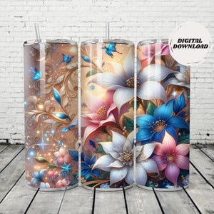 May include: Three stainless steel tumblers with floral designs. The tumblers feature a variety of flowers in shades of pink, blue, and white, with gold accents and butterfly details. Each tumbler has a straw and the words "DIGITAL DOWNLOAD" on one.