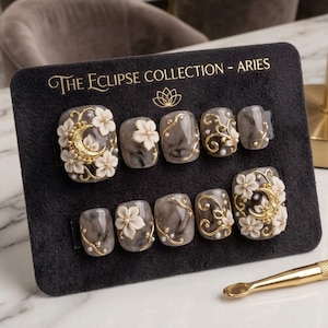 May include: A set of three ceramic mugs with a speckled, matte finish. The mugs are in shades of cream, light gray, and dark gray. Each mug has a simple, minimalist design, perfect for coffee or tea.