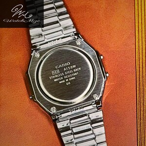 May include: A close-up of a Casio A158W digital watch, with a stainless steel back and strap. The watch face displays the Casio logo and model details. The watch is water-resistant and made in China.
