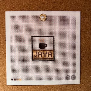 May include: A square white needlepoint canvas featuring a centered graphic of a black coffee cup with steam above the word JAVA in a brown rectangular box. A small pearl-topped pin is at the top center, and the letters CC are in the bottom right.