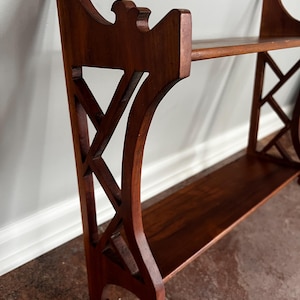 May include: A white ceramic mug with a black handle and the text "But First, Coffee" in a black, handwritten-style font. The mug is on a white surface.