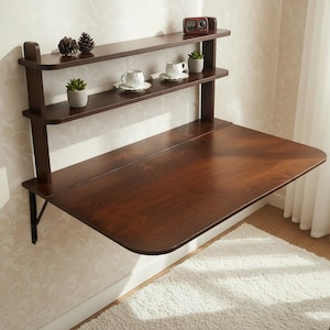 Dark walnut wall mounted murphy desk with shelves folded up flat against the wall. Space saving drop leaf folding table made of premium Baltic birch plywood for compact home office, apartment, and small space storage solution.