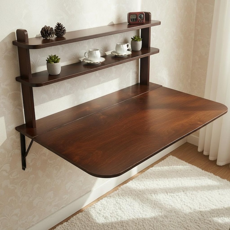 Dark walnut wall mounted murphy desk with shelves folded up flat against the wall. Space saving drop leaf folding table made of premium Baltic birch plywood for compact home office, apartment, and small space storage solution.