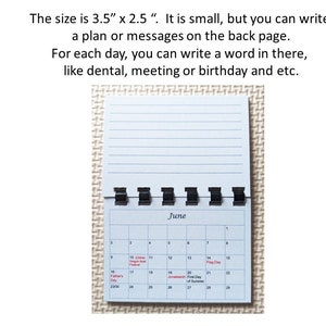 May include: A small, open, spiral-bound calendar with a blue cover and lined pages. The calendar shows the month of June with dates and holidays. Text on the image reads: "The size is 3.5" x 2.5"." and "For each day, you can write a word in there, like dental, meeting or birthday and etc."