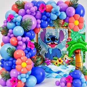 May include: A vibrant balloon arch in shades of blue, purple, and coral, decorated with tropical flowers and green leaves. A backdrop features a cartoon character and a palm tree, creating a festive party decoration.