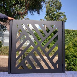 May include: Black metal gate with a geometric design featuring a series of diagonal lines.